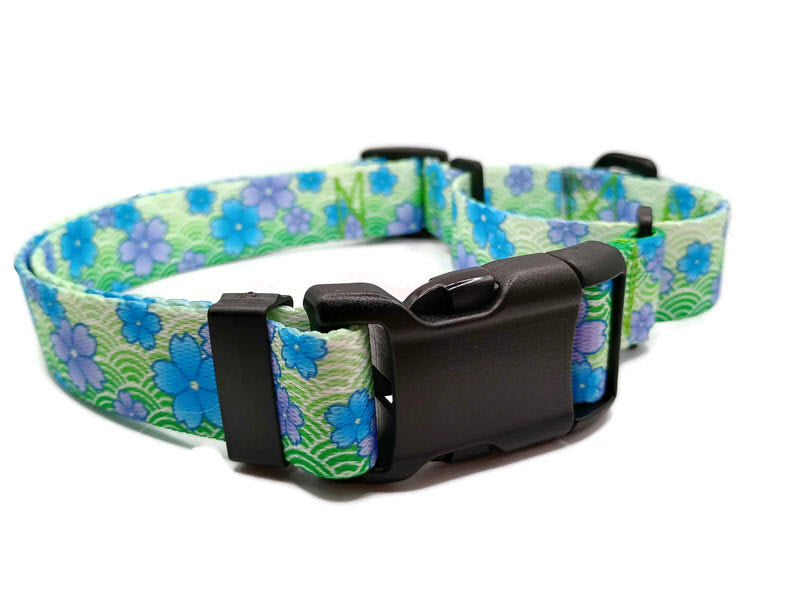 This image displays a beautiful Blue Blossom print on a spring green background. Unlike our typical metal free TSA martingales, this collar features a quick release buckle in a martingale style for easy on and off! Take the hassle out of adjusting to put it over the head and then fitting to the pups neck. Simply unclip this collar, adjust to size and snap it on! No more adjusting for on and off.