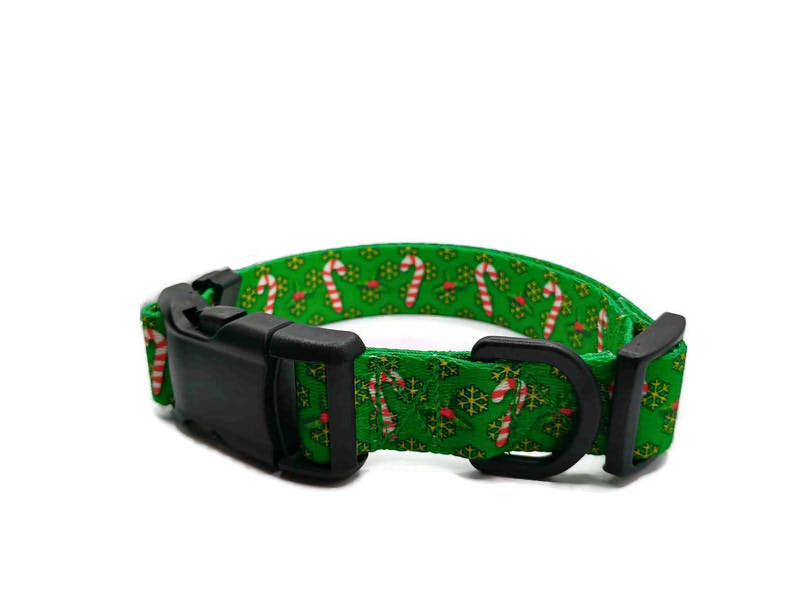 Festive red and white candy canes on a christmas green background with yellow-golden snowflakes. This collar features plastic hardware, which is ideal for dogs allergic to metal or service dogs going thru TSA checkpoints.