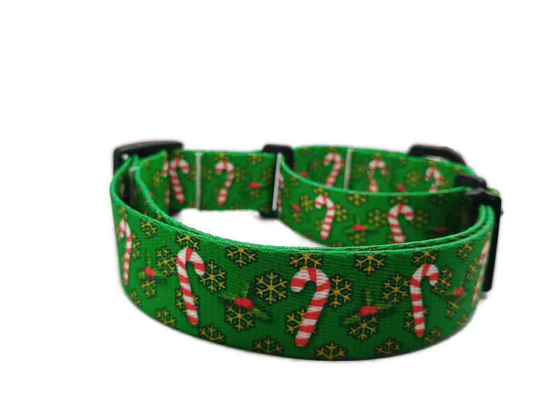 Festive red and white candy canes on a christmas green background with yellow-golden snowflakes. This collar features plastic hardware, which is ideal for dogs allergic to metal or service dogs going thru TSA checkpoints.