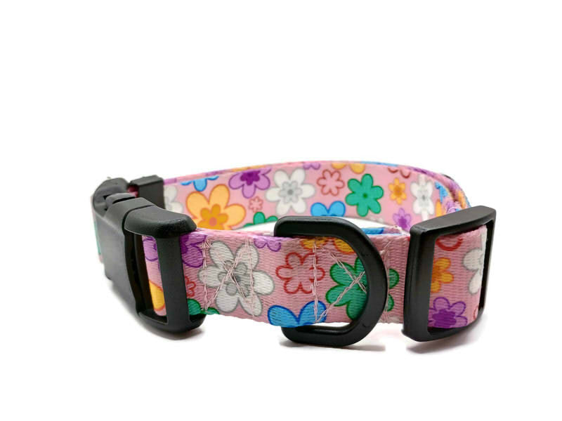 A metal free TSA friendly collar featuring all plastic hardware with beautiful colorful pansies on a baby pink background. Designed for dogs with metal allergies and services dogs thru TSA checkpoints.