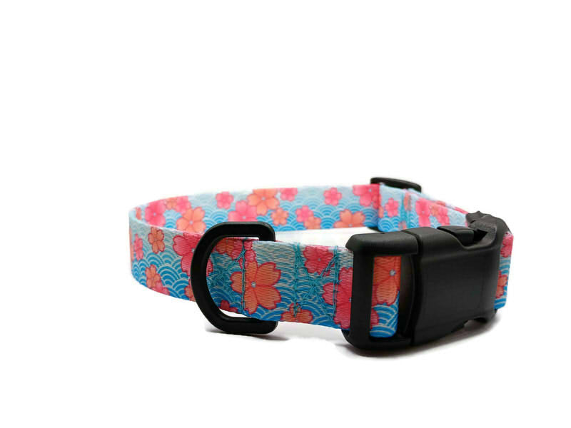 A metal free TSA friendly collar featuring all plastic hardware with beautiful pink blossoms on a spring blue background. Designed for dogs with metal allergies and services dogs thru TSA checkpoints.