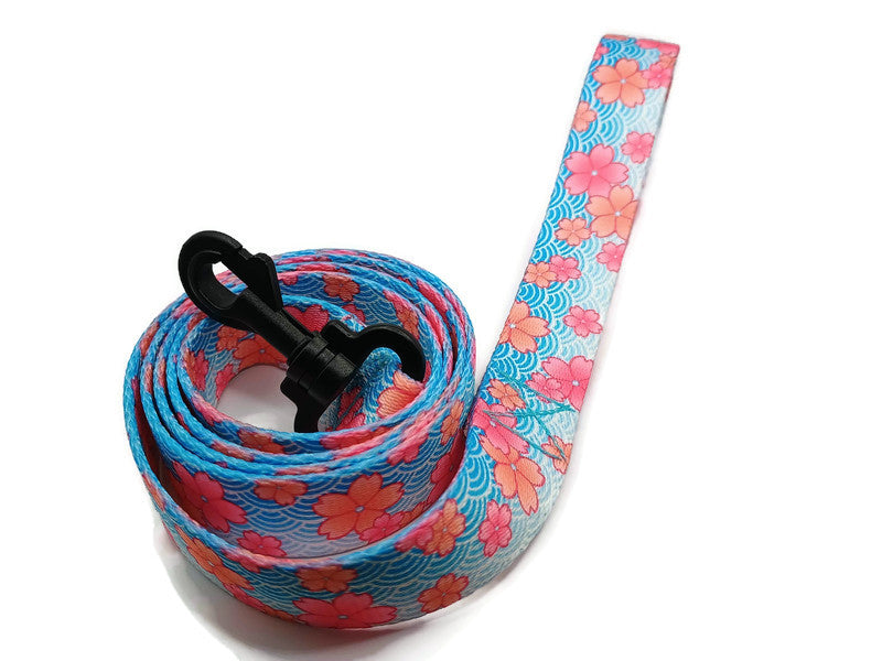 This unique leash features 2 different styles of leash clips for the owners preference! Swivel and Bolt style clips. This image features beautiful pink blossoms on a spring blue background. This leash is ideal for dogs with metal allergies or service dogs thru TSA checkpoints.