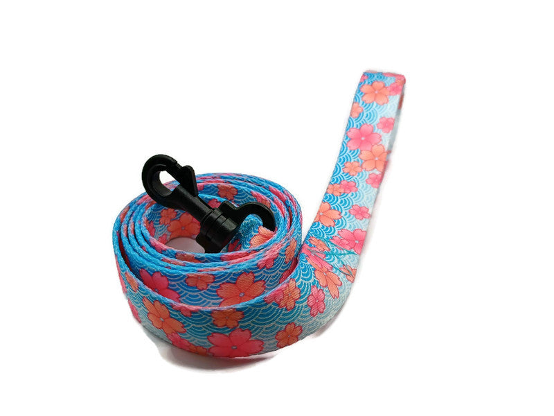 This unique leash features 2 different styles of leash clips for the owners preference! Swivel and Bolt style clips. This image features beautiful pink blossoms on a spring blue background. This leash is ideal for dogs with metal allergies or service dogs thru TSA checkpoints.