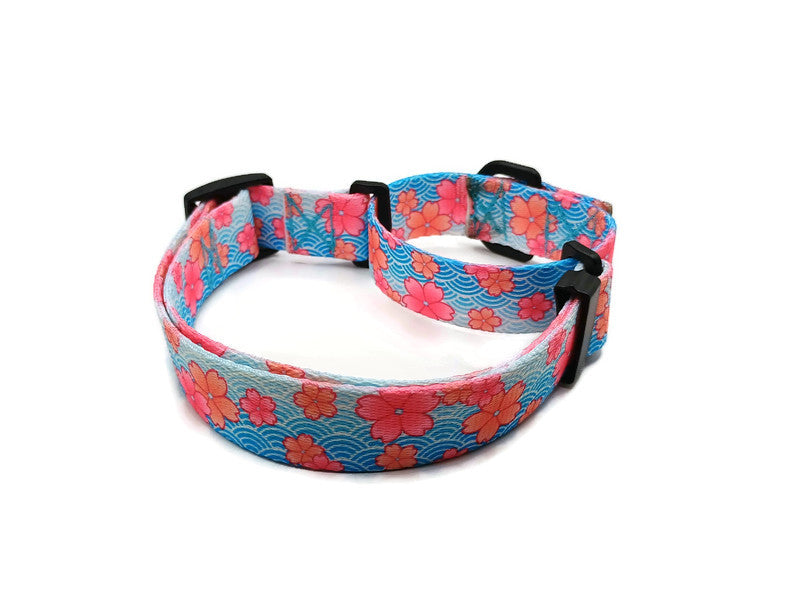 A metal free TSA friendly martingale collar featuring all plastic hardware with beautiful pink blossoms on a spring blue background. Designed for dogs with metal allergies and services dogs thru TSA checkpoints.