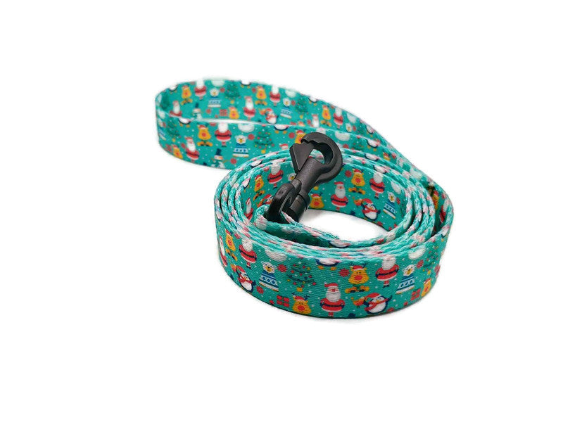 Santa & his friends; Rudolph, polar bears and penguins on a light teal background with Christmas trees scattered about. Featuring 2 leash clip styles; swivel clips or bolt snaps! Completely metal free, ideal for dogs with metal allergies or TSA checkpoints.
