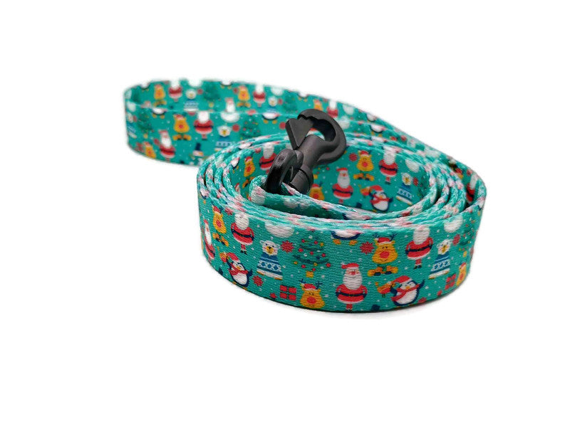 Santa & his friends; Rudolph, polar bears and penguins on a light teal background with Christmas trees scattered about. Featuring 2 leash clip styles; swivel clips or bolt snaps! Completely metal free, ideal for dogs with metal allergies or TSA checkpoints.