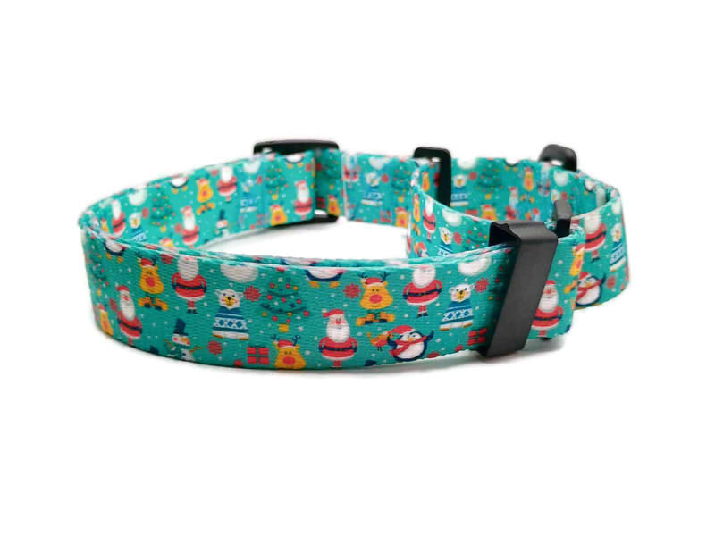 Santa and his friends; Rudolph, polar bear and penguins are celebrating Christmas on a light teal background with scattered Christmas trees. This collar features plastic hardware, which is ideal for dogs allergic to metal or service dogs going thru TSA checkpoints.