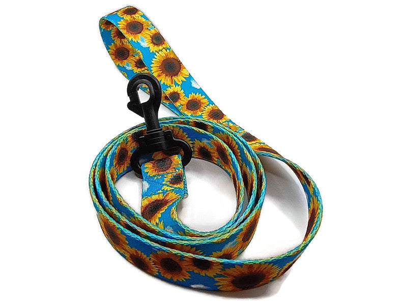 This unique leash features 2 different styles of leash clips for the owners preference! Swivel and Bolt style clips. This image features stunning Sunflowers a sky blue background. This leash is ideal for dogs with metal allergies or service dogs thru TSA checkpoints.