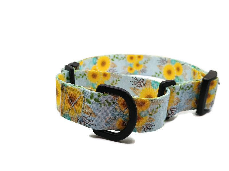 A metal free TSA friendly martingale collar featuring all plastic hardware with beautiful yellow daisies on a light blue background. Designed for dogs with metal allergies and services dogs thru TSA checkpoints.