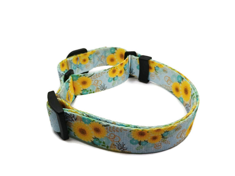 A metal free TSA friendly martingale collar featuring all plastic hardware with beautiful yellow daisies on a light blue background. Designed for dogs with metal allergies and services dogs thru TSA checkpoints.